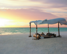 Dine by Design romantic set-up on the beach at sunset - HR